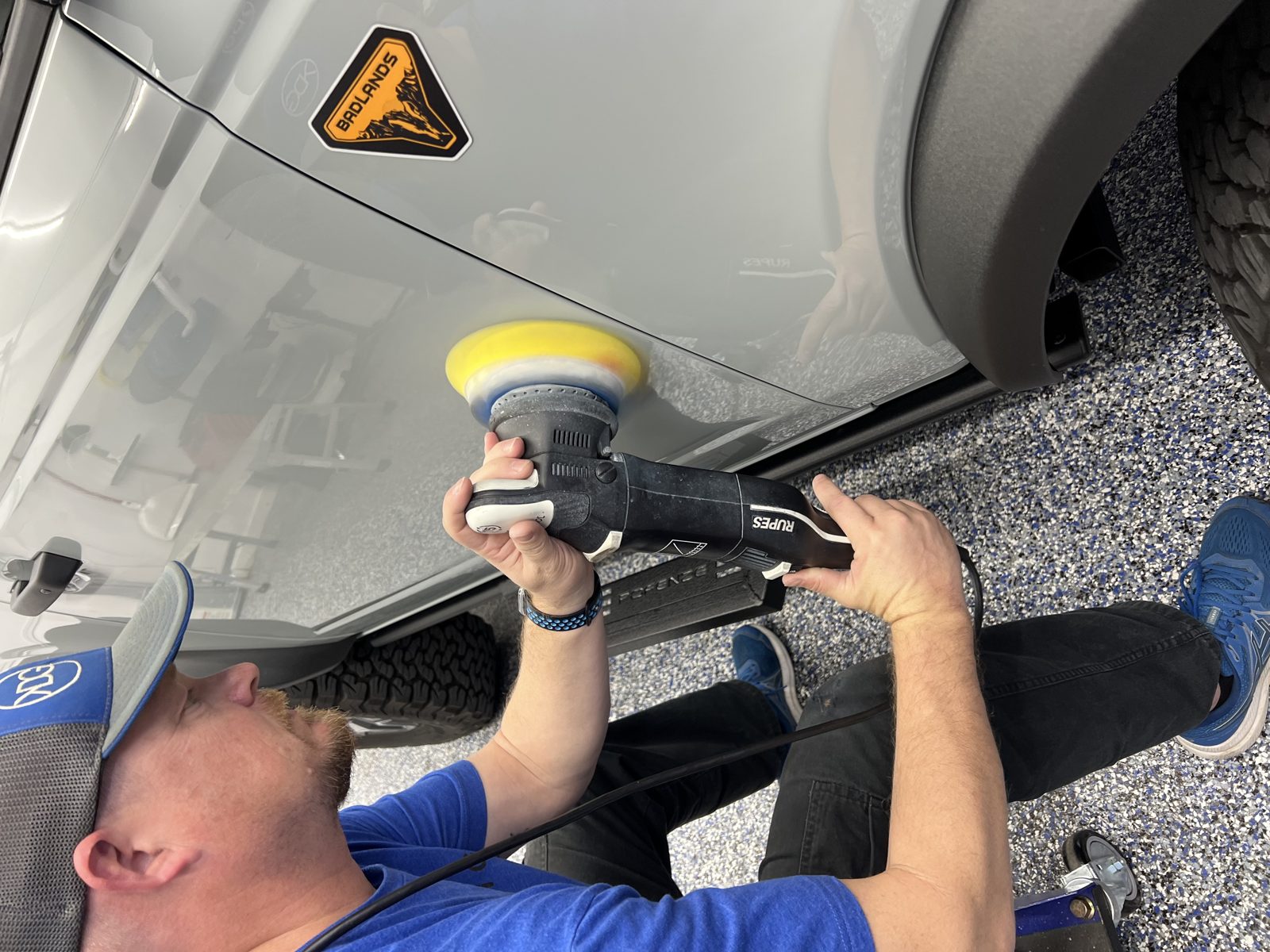 Kyle polishing a white car before coating